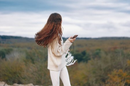 Mountain Womans Smartphone Selfie: Capturing Joyful Adventure in Nature
