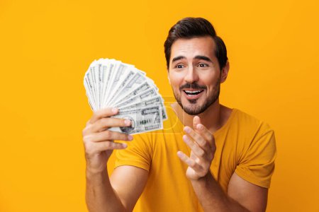 Photo for Cash man dollar wealth smiling studio currency saving hand yellow banknote shopping finance surprised profit rich credit business background money success excited investment casino happy - Royalty Free Image