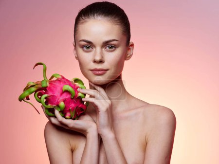 Photo for Exotic Tropical Beauty Stylish Young Woman Posing with Dragon Fruit on Vibrant Pink Background - Royalty Free Image
