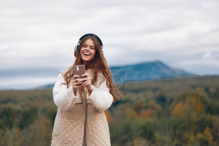 Mountain Freedom: Woman Smiling, Taking a Selfie on Her Phone during an Adventure Hiking Trip.
