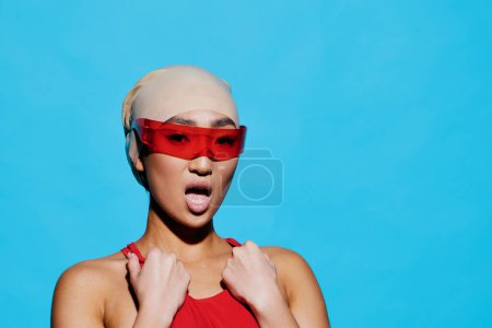 Woman trendy white person sunglasses fashion glamour young female emotion blue fun beauty studio portrait asian vacation caucasian red expression positive smiling swimwear