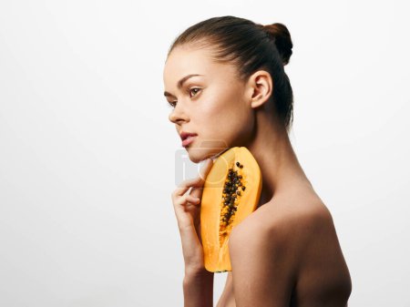 Photo for Beautiful woman holding ripe papaya fruit against white background for healthy eating and skincare concept - Royalty Free Image