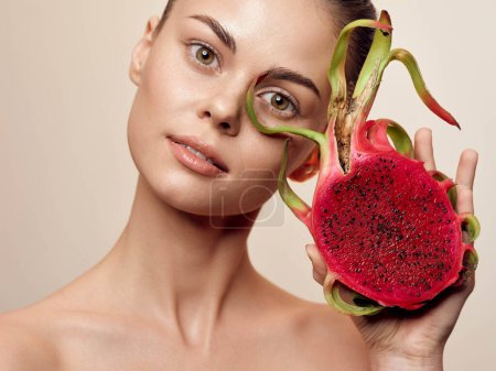 Photo for Beautiful young woman with dragon fruit facial mask showcasing healthy skin and hair beauty routine - Royalty Free Image