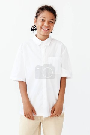Confident young boy in stylish outfit poses in trendy setting, exuding self-assurance and fashion sense.