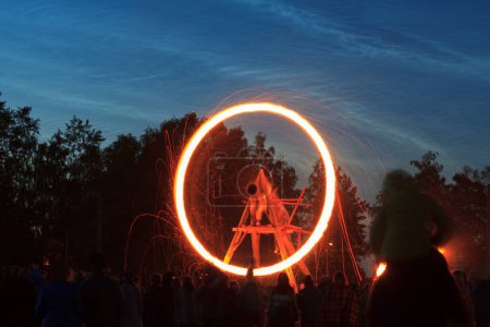 Foto de La rueda de fuego y las nubes Noctilucent. Letonia celebra el día de verano. - Imagen libre de derechos
