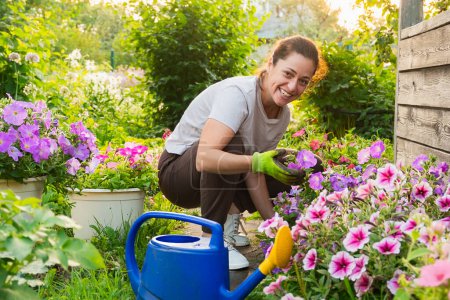 Photo for Gardening and agriculture concept. Young woman farm worker gardening flowers in garden. Gardener planting flowers for bouquet. Summer gardening work. Girl gardening at home in backyard - Royalty Free Image