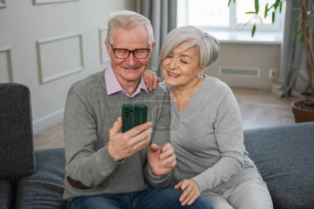 Photo for Video call. Happy senior couple woman man with smartphone having video call. Mature old grandmother grandfather talking speaking online. Older generation modern tech usage. Virtual meeting online chat - Royalty Free Image