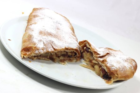 Photo for Typical artisanal cake strudel with apples and raisins and cinnamon - Royalty Free Image