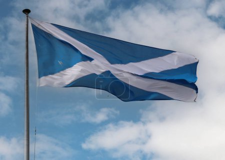 The national flag of scotland, the saltire, waving proudly on a cloudy day