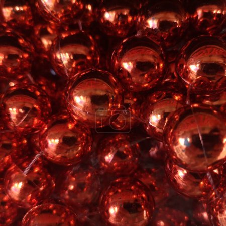 Close-up view of shiny red christmas baubles clustered together