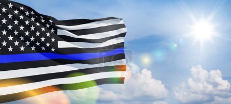 Foto de American flag with police support symbol Thin blue line on blue sky. American police in society as the force which holds back chaos, allowing order and civilization to thrive. Banner. - Imagen libre de derechos