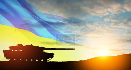 Silhouette of army tank at sunset sky background with Ukrainian flag. Shipping a huge, wide-ranging package of heavy weapons to Ukraine.
