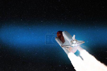 Foto de Spaceship lift off. Space shuttle with smoke and blast takes off into the starry sky. Rocket starts into space. Concept. Elements of this image furnished by NASA. - Imagen libre de derechos
