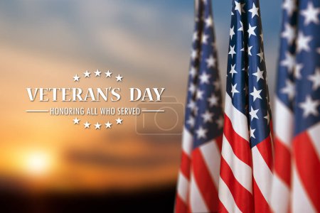 Photo for American flags with Text Veterans Day Honoring All Who Served on sunset background. American holiday banner. - Royalty Free Image