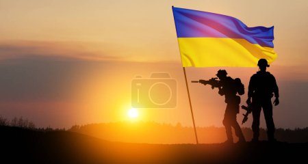 Photo for Flag of Ukraine with silhouette of soldiers against the sunrise or sunset. Concept - armed forces of Ukraine. Relationship between Ukraine and Russia. - Royalty Free Image