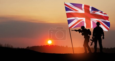 Silhouettes of soldiers with United Kingdom flag on background of sunset. Greeting card for Poppy Day, Remembrance Day. United Kingdom celebration.