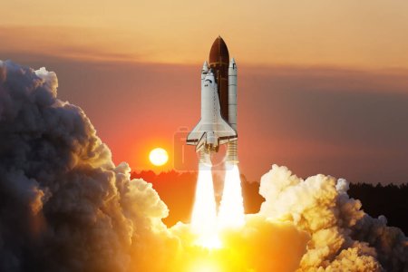 Photo for Spaceship lift off. Space shuttle with smoke and blast takes off into space on a background of sunset. Successful start of a space mission. Elements of this image furnished by NASA. - Royalty Free Image