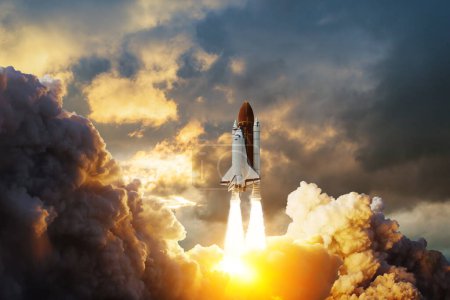 Spaceship lift off. Space shuttle with smoke and blast takes off into space on a background of sunset. Successful start of a space mission. Elements of this image furnished by NASA.