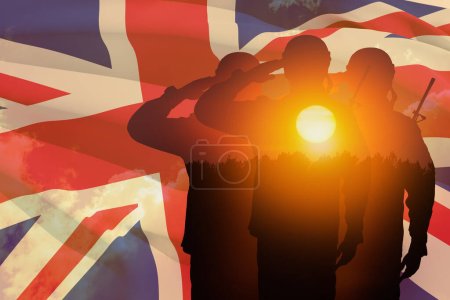 Silhouettes of soldiers with print of sunset saluting on a background of United Kingdom flag. Greeting card for Poppy Day, Remembrance Day. United Kingdom celebration.