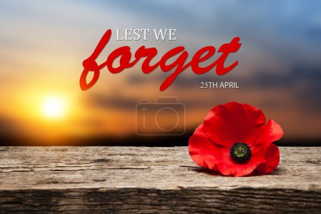 Photo for Poppy pin for Anzac Day. Poppy flower on old beautiful high grain, detailed wood on background of sunset sky. Lest We Forget. - Royalty Free Image