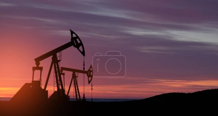 Photo for The change in oil prices caused by the war. Oil prices are rising because of the global crisis. Oil drilling derricks at desert oilfield. Crude oil production from the ground. Petroleum production. - Royalty Free Image