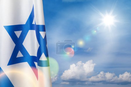Israel flag with a star of David over cloudy sky background. Patriotic concept about Israel with national state symbols. Banner with place for text.