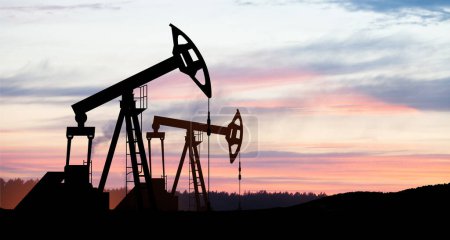 Photo for The change in oil prices caused by the war. Oil price cap concept. Oil drilling derricks at desert oilfield. Crude oil production from the ground. Petroleum production. - Royalty Free Image