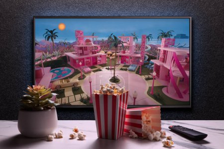 Photo for TV screen playing Barbie trailer or movie. TV with remote control, popcorn boxes and home plant. Astana, Kazakhstan - July 2, 2023. - Royalty Free Image