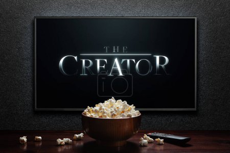 Photo for The Creator trailer or movie on TV screen. TV with remote control and popcorn bowl. Astana, Kazakhstan - September 23, 2023. - Royalty Free Image