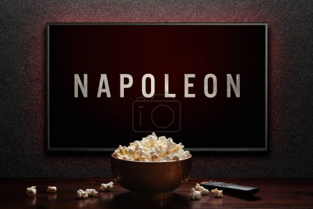 Photo for Napoleon trailer or movie on TV screen. TV with remote control and popcorn bowl. Astana, Kazakhstan - July 2, 2023. - Royalty Free Image