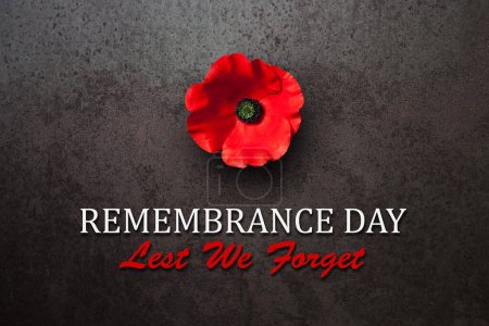 Photo for Remembrance Day Lest We Forget inscription with Poppy flower on rusty iron background. Decorative flower for Remembrance Day. Memorial Day. Veterans day. - Royalty Free Image