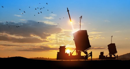 Photo for Israel's Iron Dome air defense missile launches. The missiles are aimed at the sky at sunset. Missile defense, a system of salvo fire. - Royalty Free Image