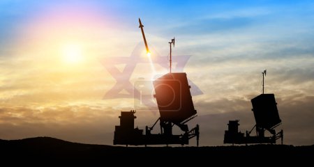 Photo for Israel's Iron Dome air defense missile launches. The missiles are aimed at the sky at sunset with Israel flag. Missile defense, a system of salvo fire. - Royalty Free Image