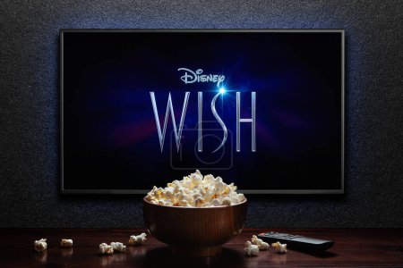 Photo for Wish trailer or movie on TV screen. TV with remote control and popcorn bowl. Astana, Kazakhstan - November 15, 2023. - Royalty Free Image