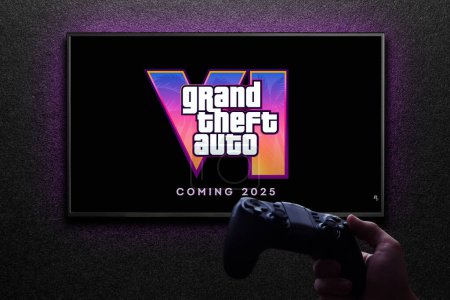 Photo for Grand Theft Auto 6 trailer game on TV screen with gamepad in hand on black textured wall with light. Astana, Kazakhstan - December 5, 2023. - Royalty Free Image