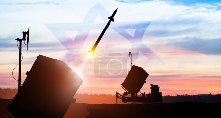 Photo for Closeup of Israel's Iron Dome air defense missile launches. The missiles are aimed at the sky at sunset with Israel flag. Missile defense, a system of salvo fire. - Royalty Free Image