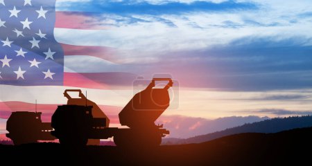 Artillery rocket system are aimed to the sky at sunset with USA flag. Multiple launch rocket system. Greeting card for Veterans Day, Memorial Day, Independence Day. America celebration.