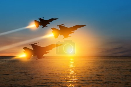 Photo for Air Force Day. Aircraft silhouettes on background of sunset on the sea. - Royalty Free Image