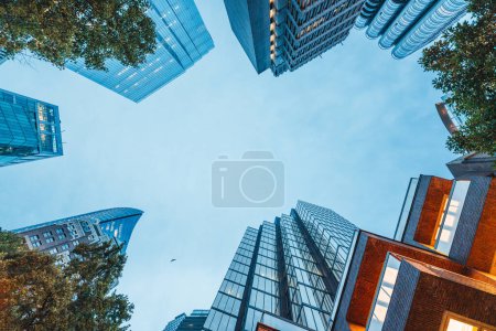 An upward glance at Vancouvers skyscrapers against a clear sky, urban and architectural themes.