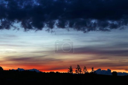 Photo for A sunset with dark, eerie rain clouds - Royalty Free Image