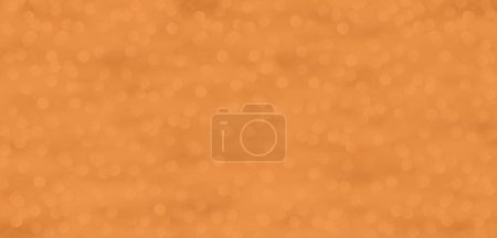 A glittering background with dots of light in Peach Fuzz