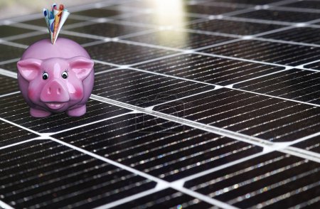 Save money with an electricity-generating solar system. Photovoltaics and piggy bank
