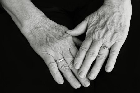 The hands of an old woman in black and white