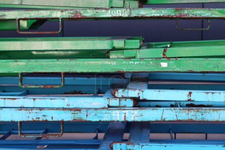 Old blue and green iron bars on a pile