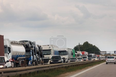 Photo for Queue of Trucks on Ukraine-Poland Border traffic jam at Sunset During Protest Roadblock. Business agricultural Logistics blockade action. Cargo lorry semi-trailers stuck. - Royalty Free Image