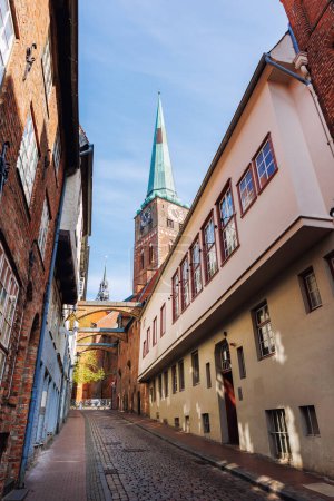 Scenic view old narrow european german Lubeck with red brick ancient houses vintage iron stained glass lamp lantern wall. Cityscape Lubeck UNESCO heritage city altstadt in Germany travel destination.