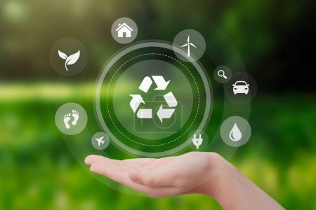 Téléchargez les photos : Hand with recycling and eco symbols. Sustainable energy sources, zero waste concept - en image libre de droit