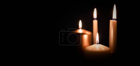 Photo for Candles burning in darkness over black background. Commemoration, necrology notice concept. - Royalty Free Image