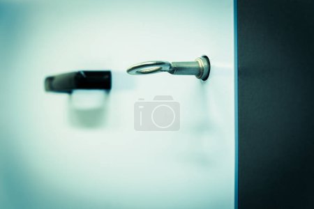 Photo for Close-up, selective focus on a key in a lock with blurred door handle in the background, concept of security - Royalty Free Image