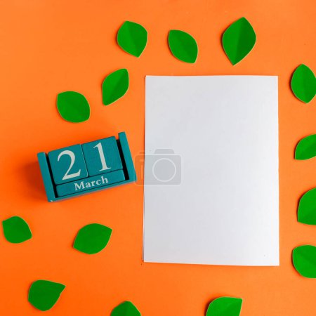 21 march. blue cube calendar and white mockup blank on bright orange background
